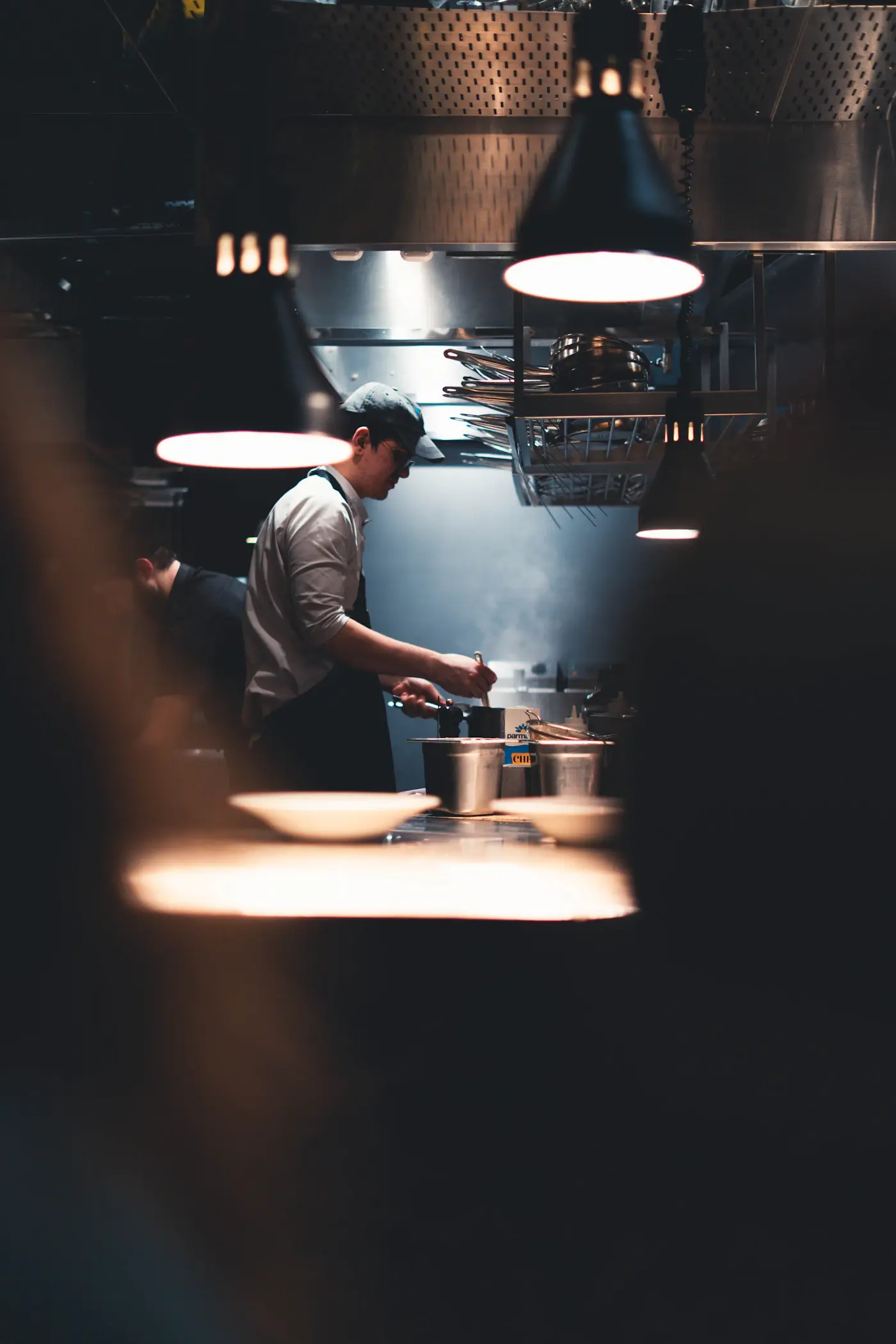 A chef preparing food in a busy kitchen